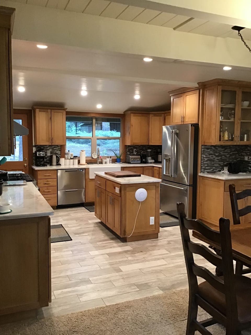 Chef's kitchen with premium cookware, appliances, plenty of dishes and glassware