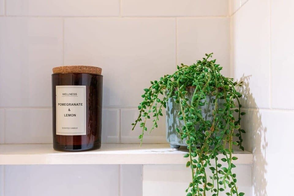 Bathroom shelf with candle and greenery


