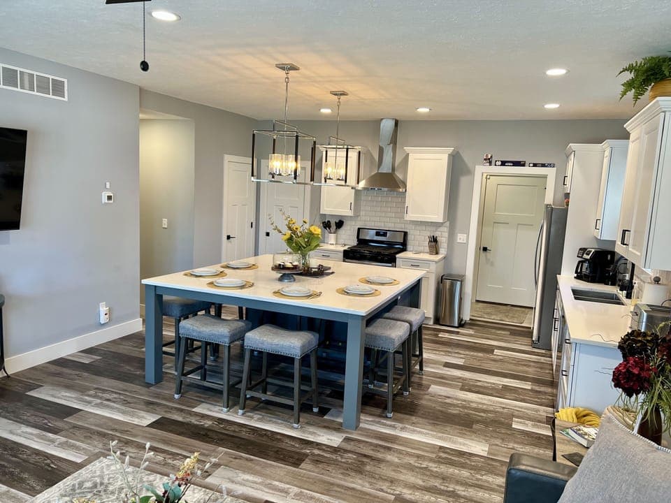Large island table doubles as kitchen seating and family gathering point.