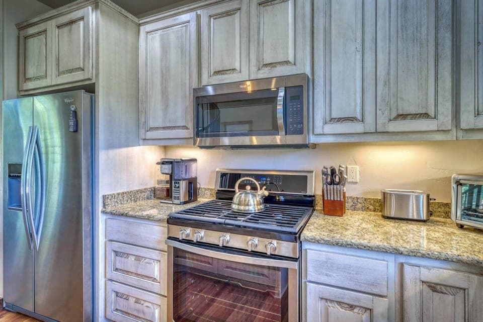 Kitchen with stainless steel appliances, and granite countertops.
