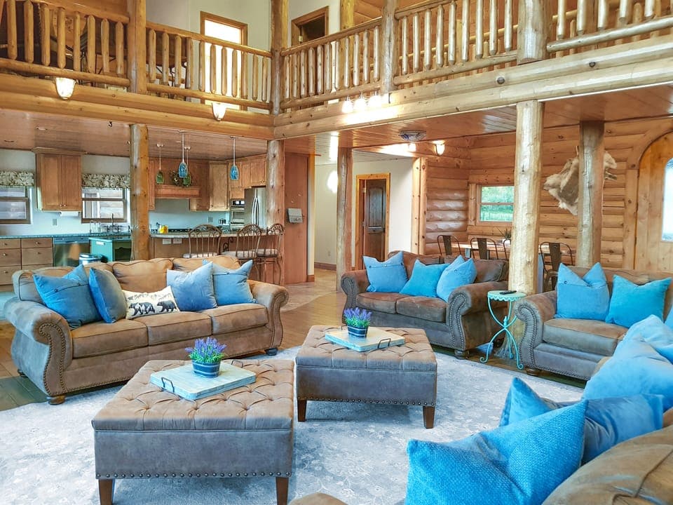 The living room has 2) full-size couches, 2) love seats, and 2) leather chairs