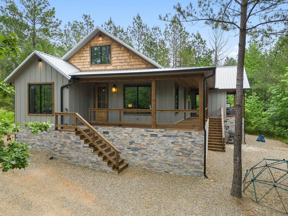 Embrace the charm of Broken Bow with this cozy cabin featuring a stunning wraparound porch—your perfect getaway in the heart of nature. 