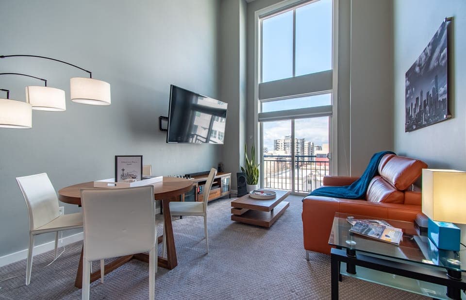 Living Room with a Large 75" TV, Vaulted Ceiling Windows & Sleeper Sofa