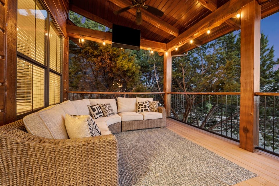 HUGE patio with ambient lighting, tons of couch space, smart tv, and dining area