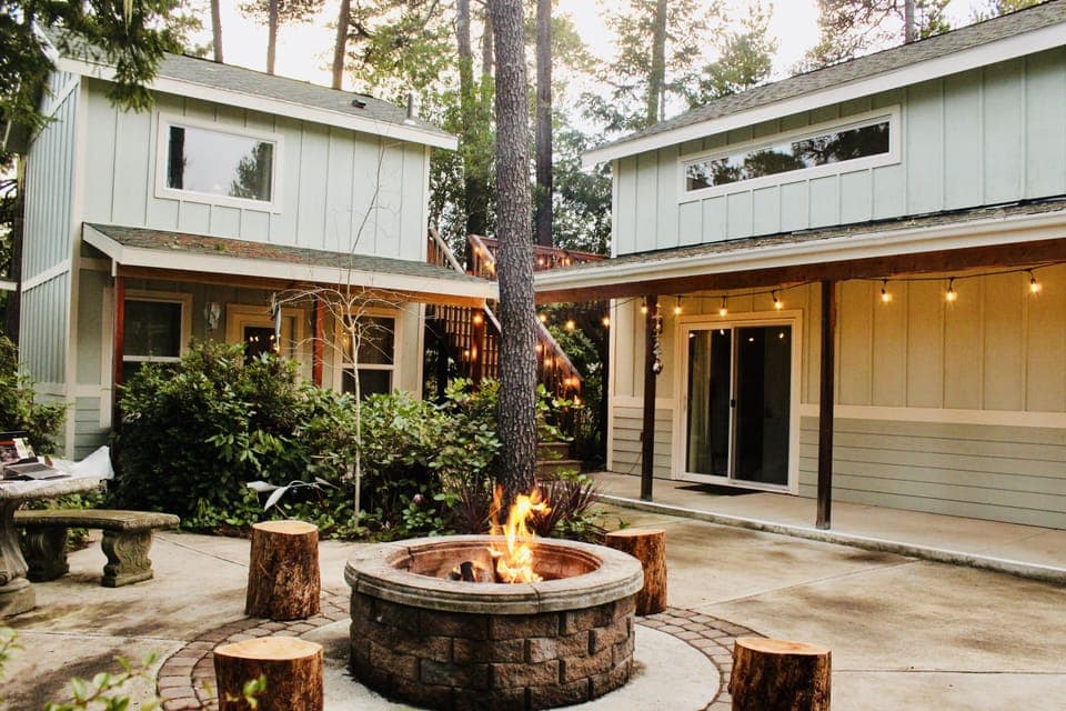 Courtyard & firepit area. Main house with covered patio area (right).
