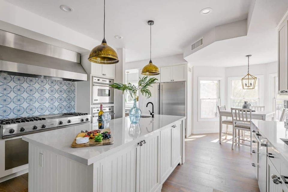 Bright fully equipped kitchen with stainless steel appliances, dual ovens, dual sinks, XL fridge, large island and breakfast table with incredible views of Camelback.