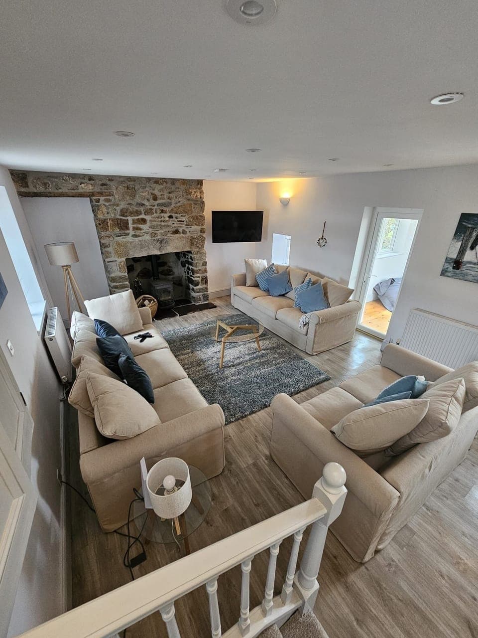 A spacious lounge with a log burner, large TV and comfy sofas to chill out on.