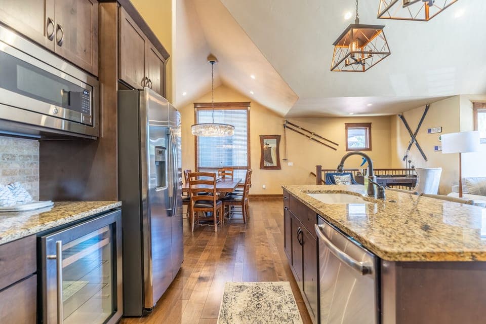 Full-sized kitchen featuring granite countertops, stainless steel appliances, and brand new light fixtures.