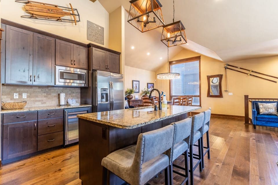 Full-sized kitchen featuring granite countertops, stainless steel appliances, and brand new light fixtures.