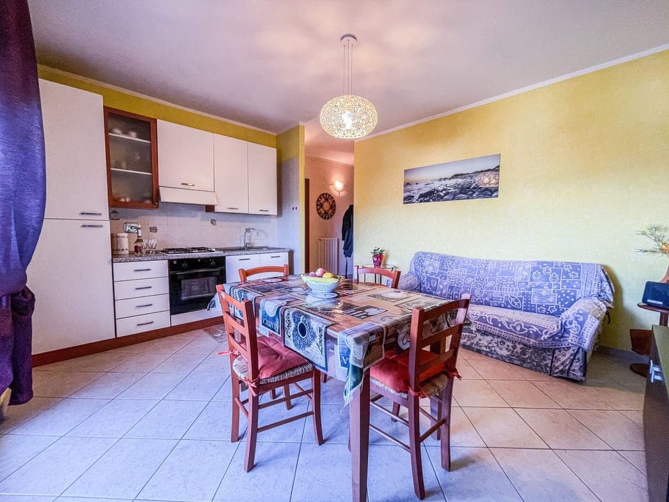Living room with kitchenette, sofa bed and flat screen TV. Large balcony, from which you can also see the Basilica of Superga