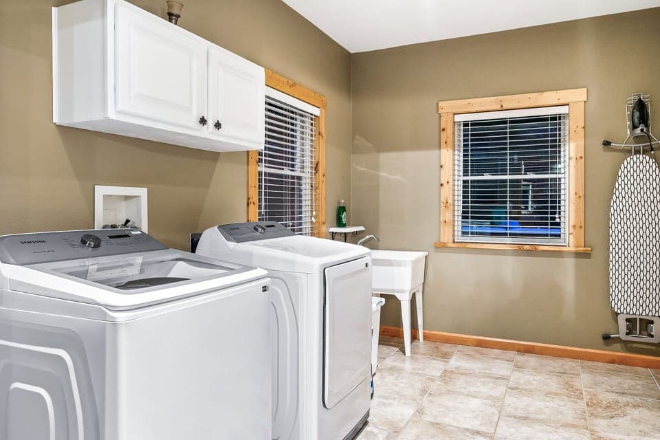 Laundry room equipped with new Samsung W&D, iron, ironing board, beach towels 