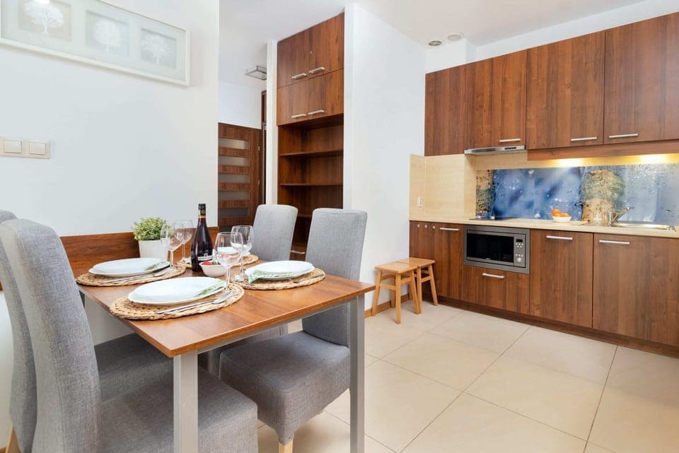 Dining area with a wooden table set for meals.
