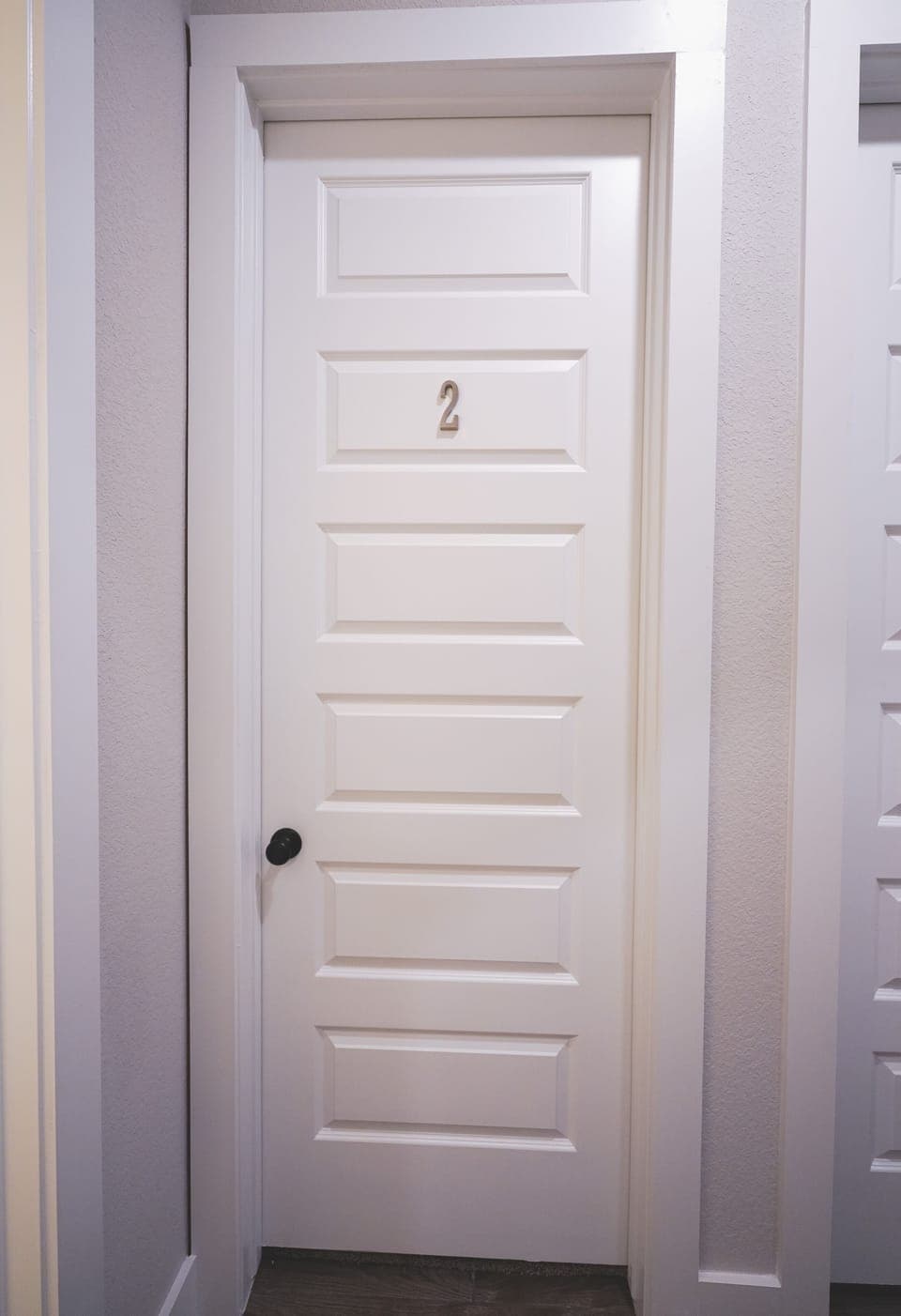 Room #2 is the first bedroom next to the shared bath on the left of the hallway.