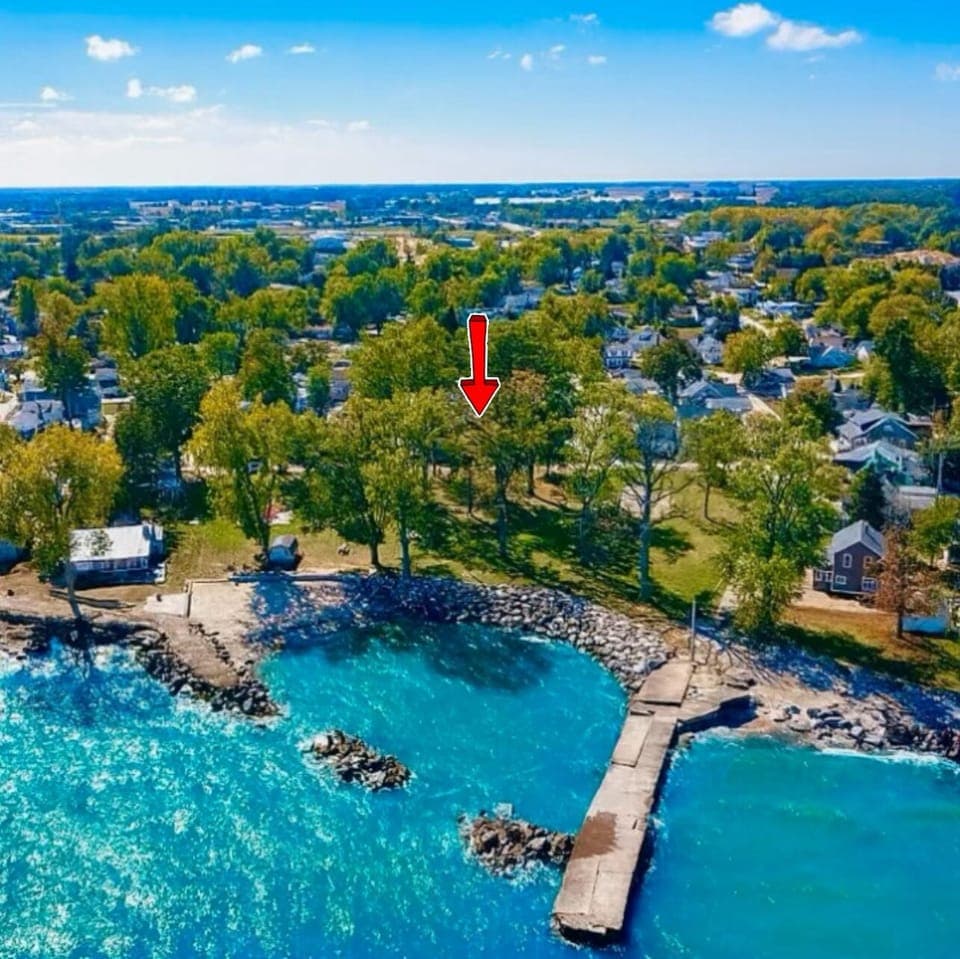 A stunning aerial view of the private beach and shoreline where The Castle sits. Enjoy peaceful lake access, open green space, and beautiful scenery just steps from your stay.

