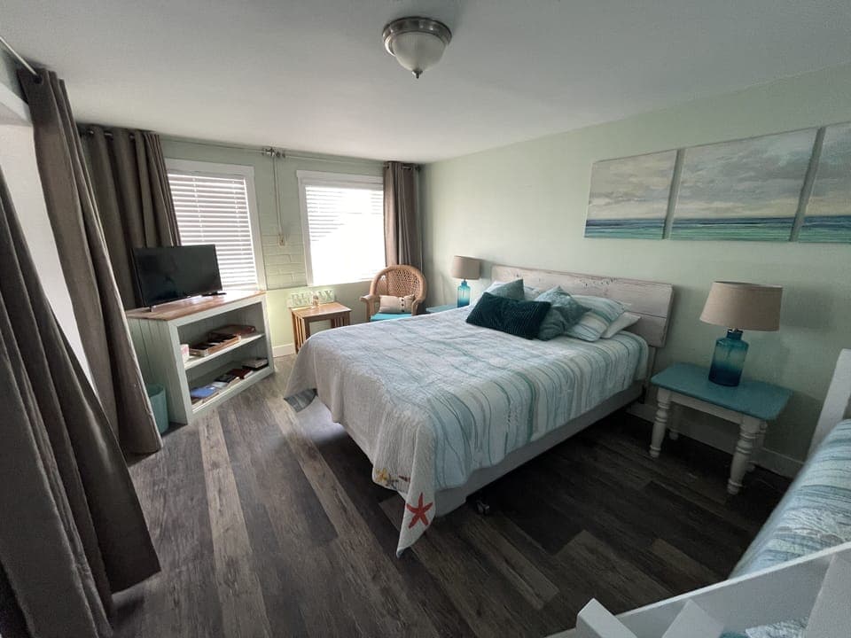 Queen bed and bunk beds (full, twin) in the bedroom; TV with DVD player