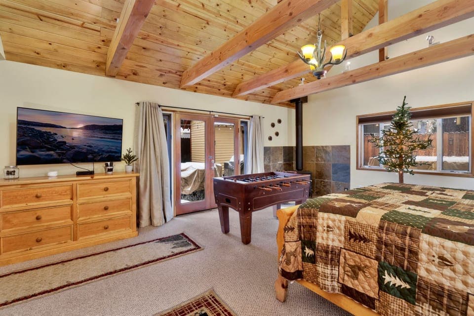 Peaceful cabin bedroom with plush bedding, and beautiful views—ideal for restful nights, cozy mornings, and a relaxing mountain escape.