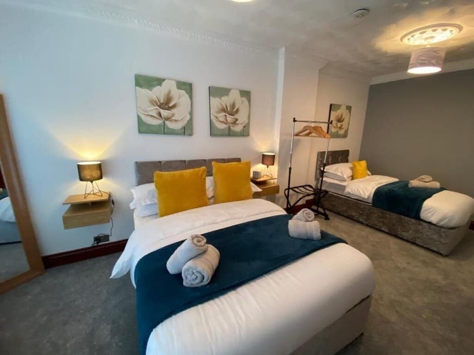 This comfortable room offers a comfortable bed with soft linens and warm lighting, creating a peaceful atmosphere. 