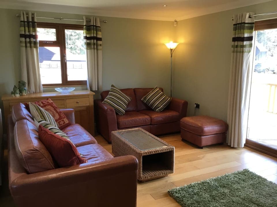 Comfortable leather sofas with view and access to the covered veranda.