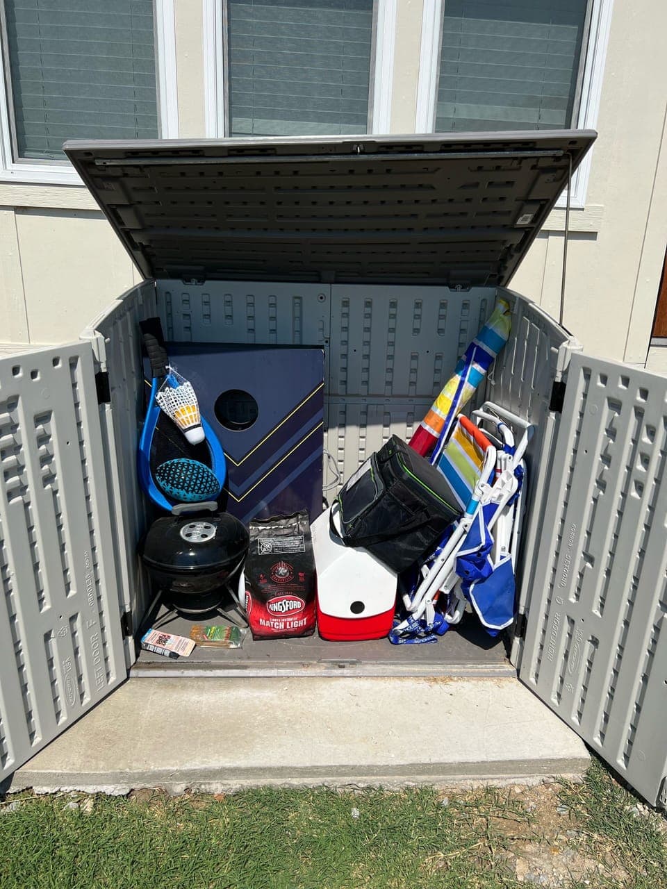 Contents of storage - 2 chairs, umbrella, beach items, corn hole, charcoal
