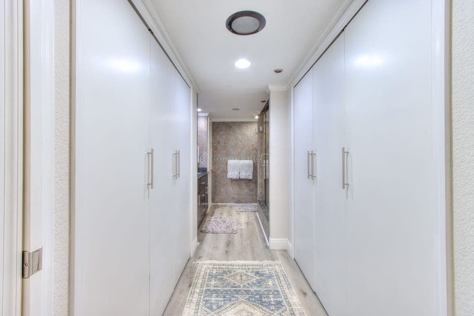Theirs & Theirs closets leading to the bathroom.