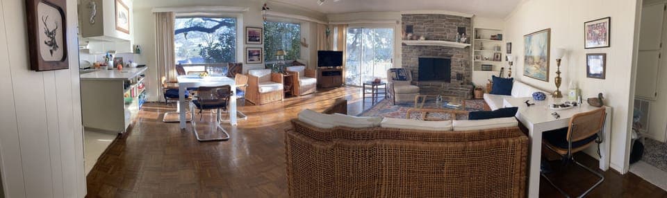 Pano view of spacious living room, windows overlooking lake