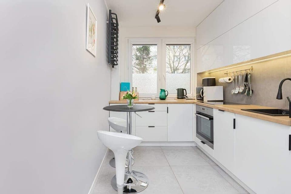 Functional kitchen with white cabinets and quality appliances that allow you to prepare home-cooked meals.