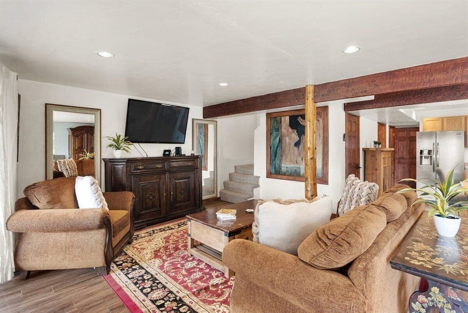 Downstairs living area with living room, fireplace, and deck space.