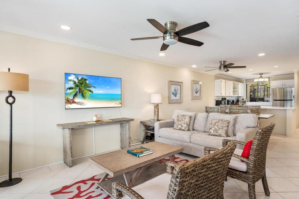 Living room with sliding doors to lanai and peekaboo ocean views