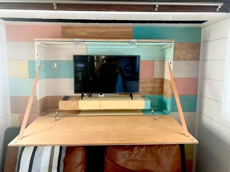 TV inside hidden shelf agains north wall