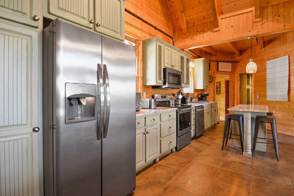 Fully equipped kitchen with stainless steel appliances in luxury Smoky Mountain vacation home.