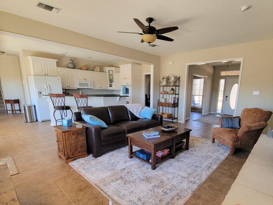 From the den, you can see the open kitchen with bar seating.