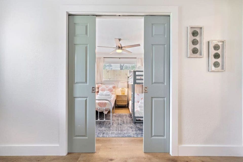 This bedroom has a queen bed & a full size bunk bed