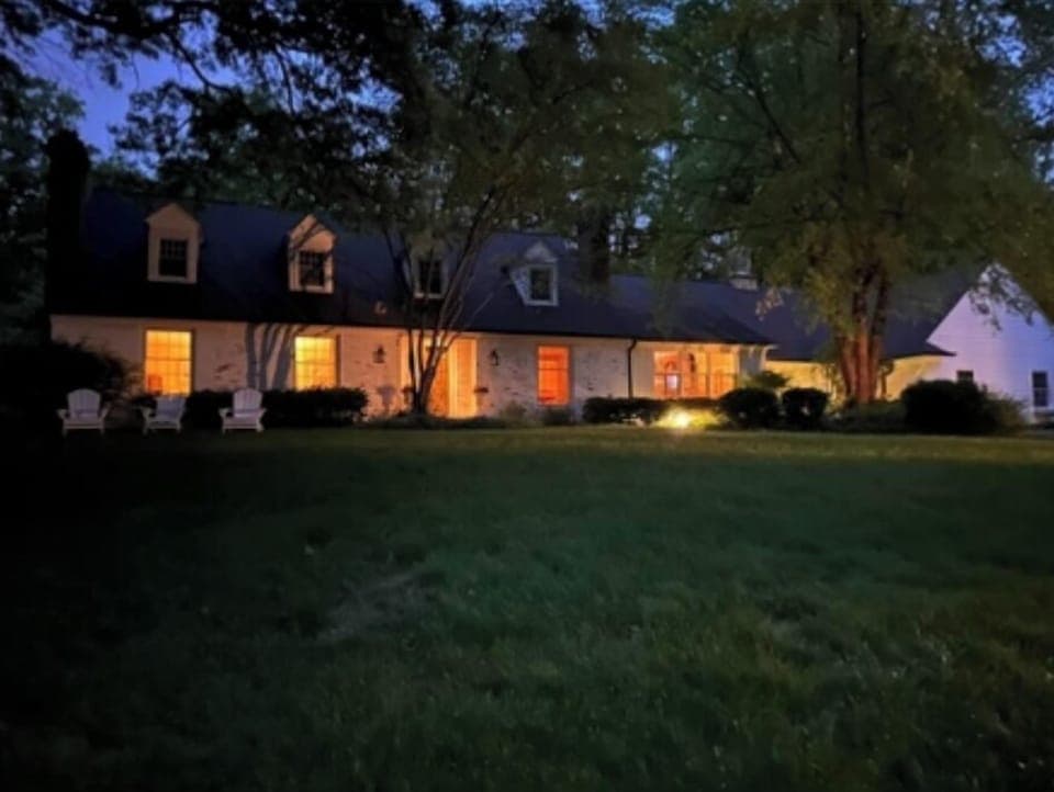 Spacious, charming Cape Cod Style home in a beautiful park-like setting.