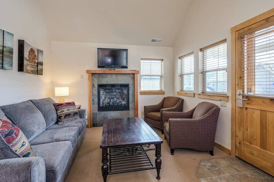 Spacious living room with sofa sleeper, smart TV and gas fireplace.