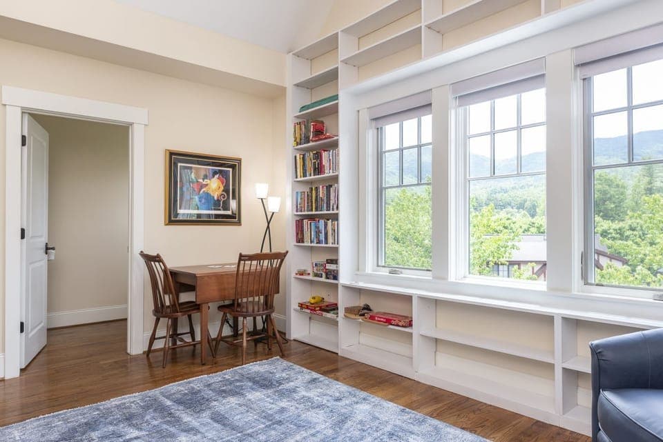 Upper-level living space with reclining couch, game table & various books to enjoy.