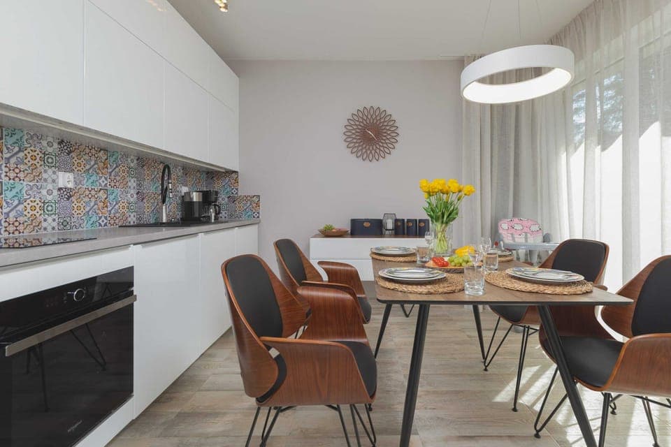Kitchenette and dining table with tableware.