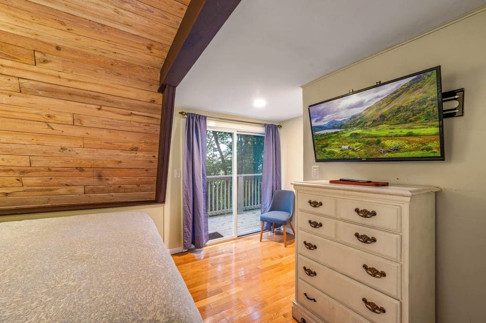 Sliding doors that lead to deck.  A TV with Roku remote is available.