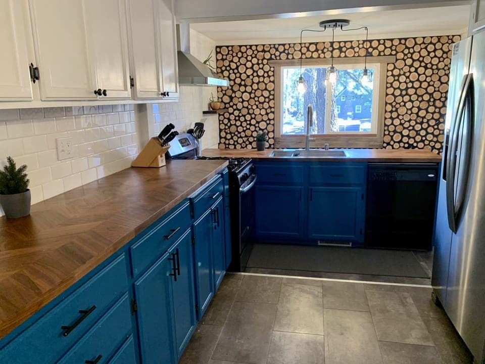 A recently renovated kitchen with log round accent wall.  Wood from the property