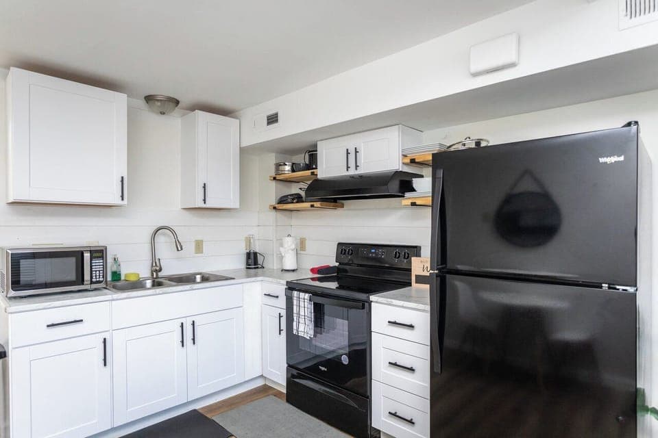 Full-size kitchen with refrigerator, stove/oven, and microwave