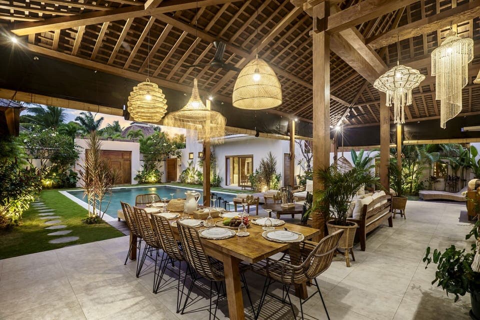 Illuminated dining area with a pool view 