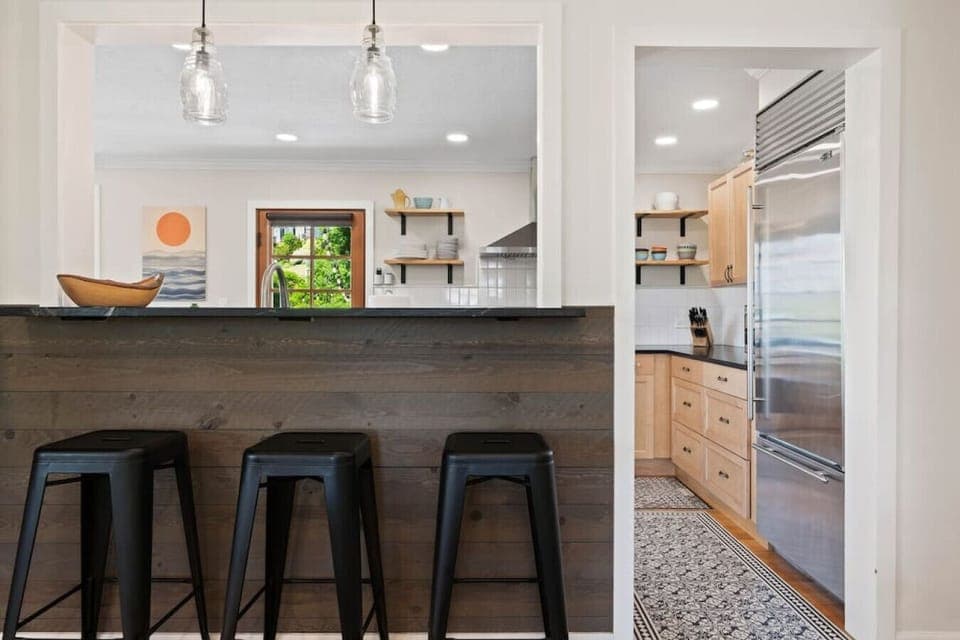 Pass-through from living room to kitchen with bar seating