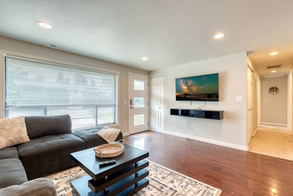 Open & inviting living room with 55" UHD TV w/ Disney + to enjoy with the family