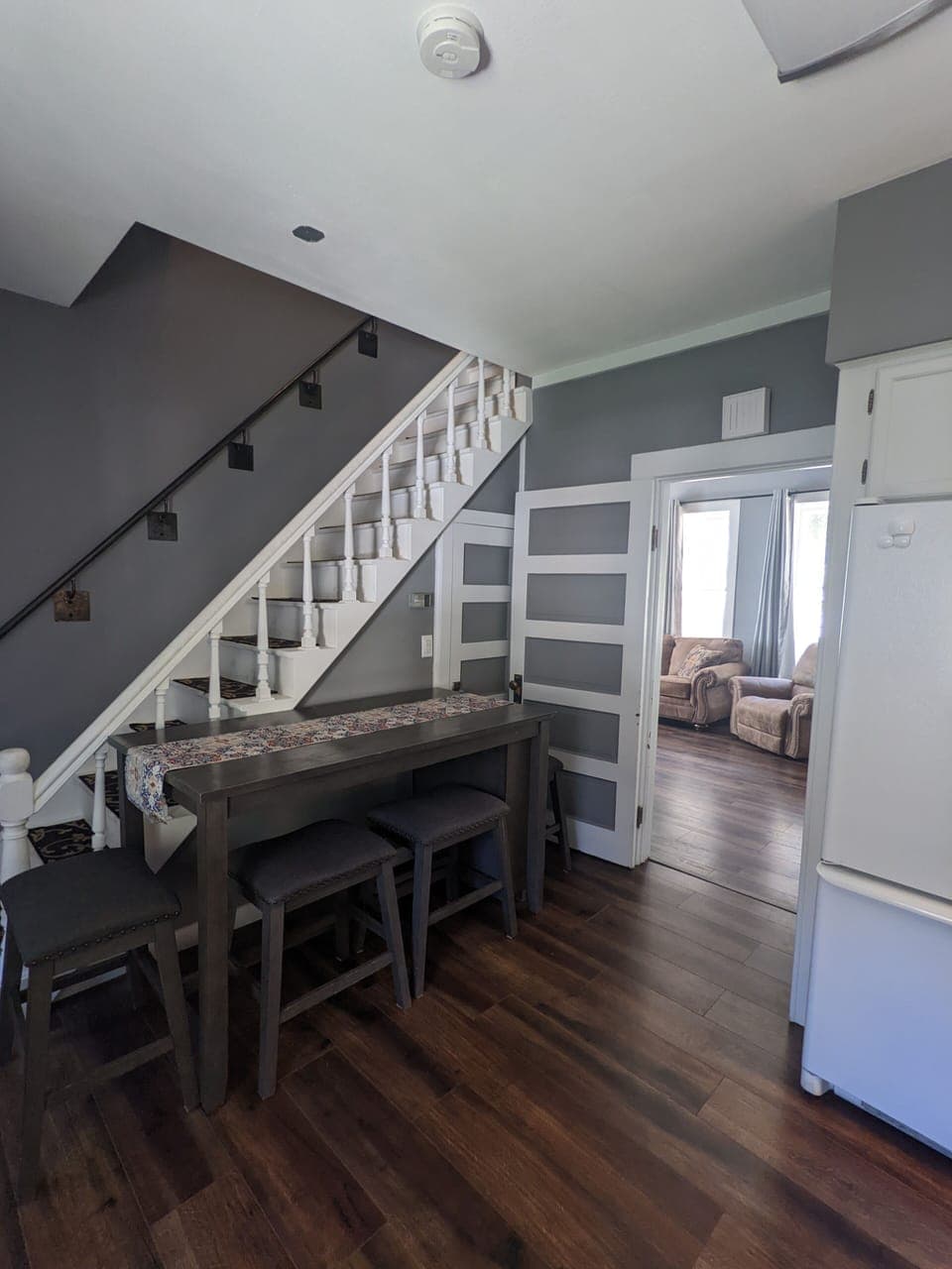 This table can seat 4. The shorter table in the living room can also seat 4.