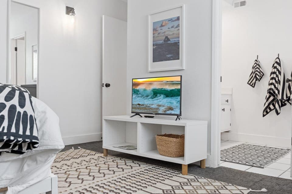 The cozy primary bedroom, with a queen bed and 43'' TV