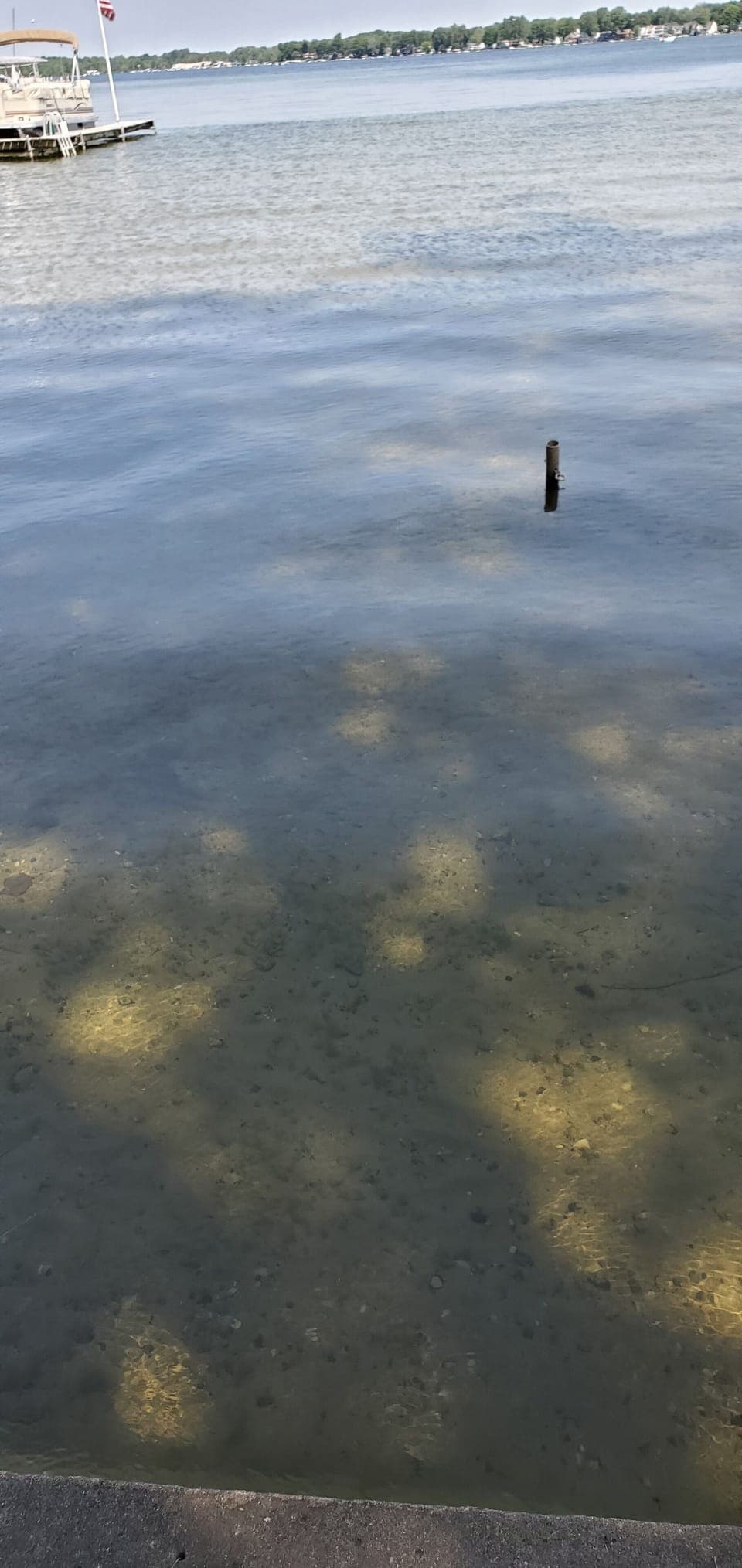 Clear water, sandy bottom.