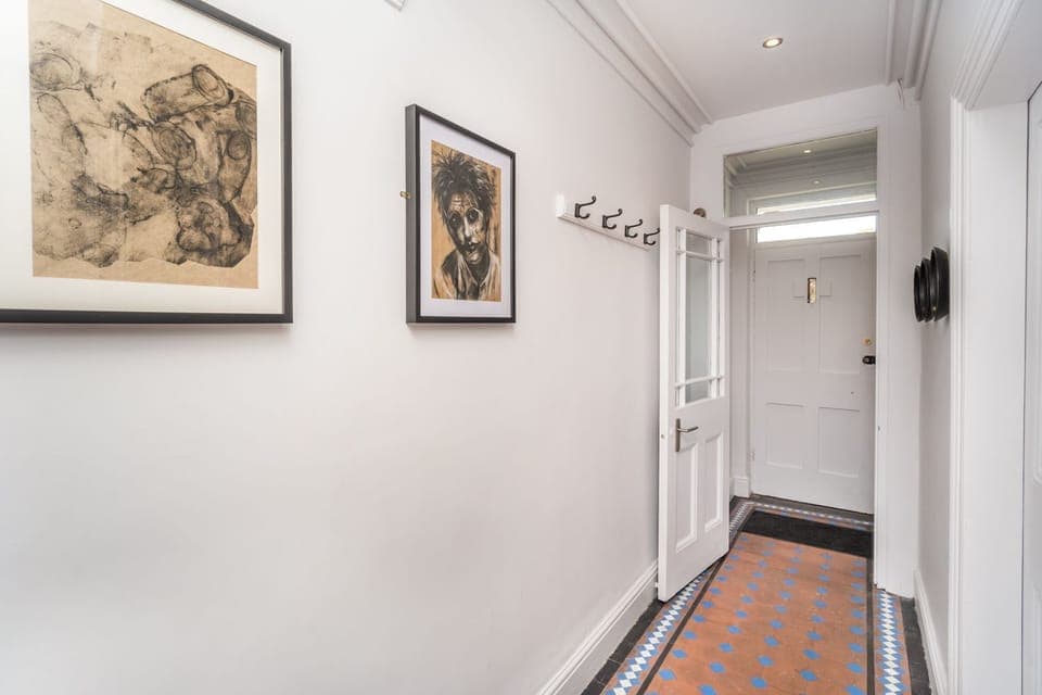 The property retains some original features, including the attractive floor tiles in the hallway