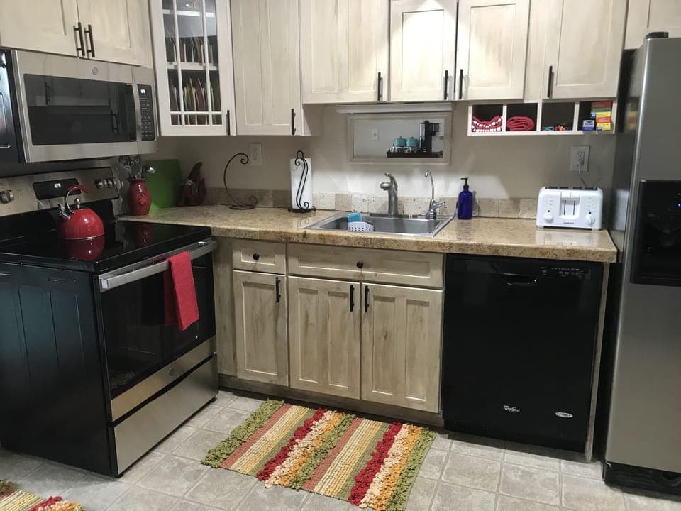 The kitchen has full-sized appliances, & the cabinets are generously equipped. 