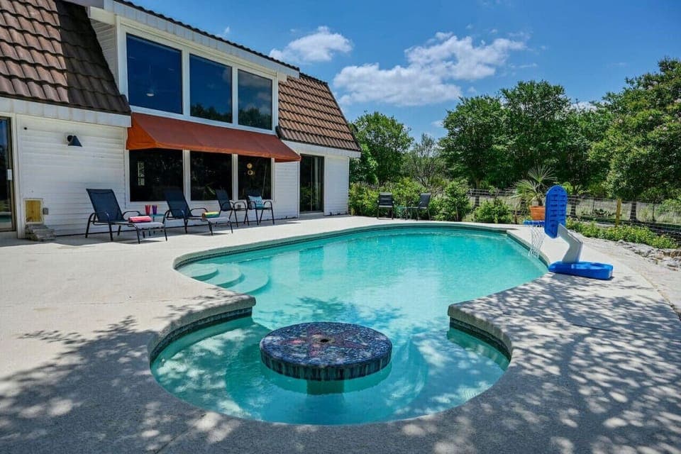 Relaxing private pool with swim-up table in Austin Hill Country