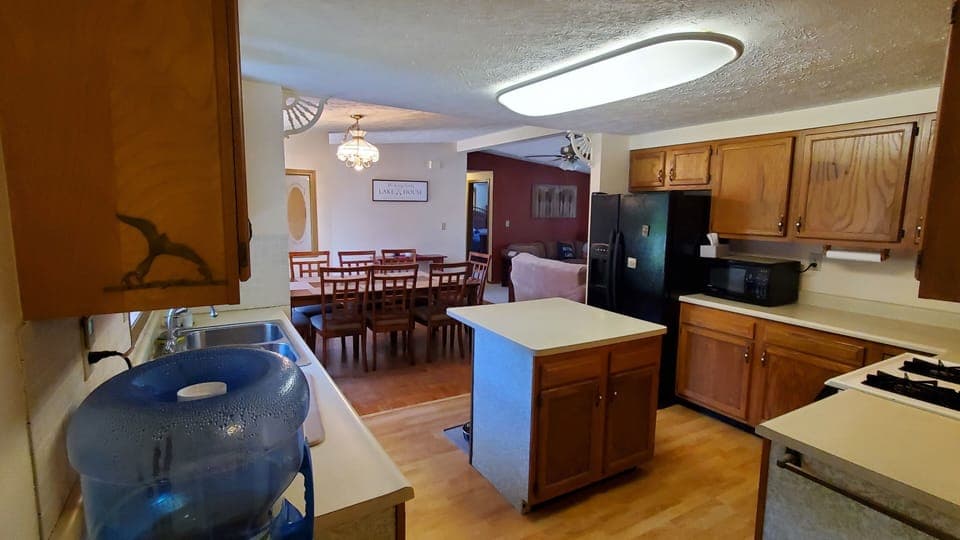 Fully stocked kitchen w/ island and dining room 