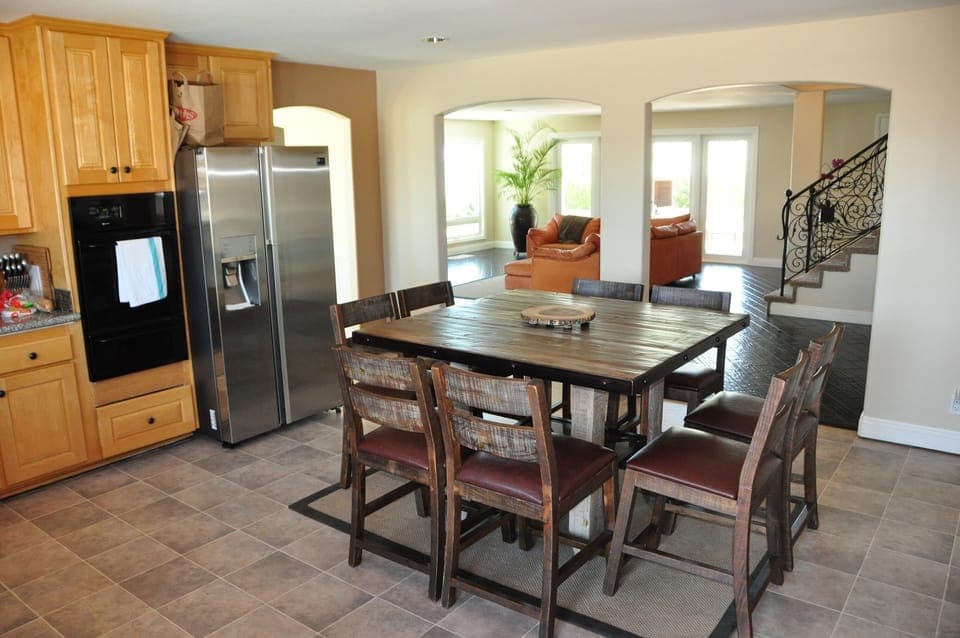 In kitchen, dining table with slider door to pool area. 